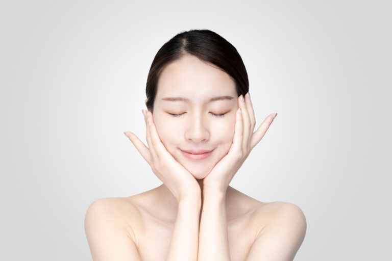 Young woman touching face with relaxed expression